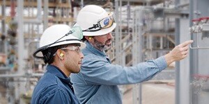 Field engineers inspecting an industrial fluid system 