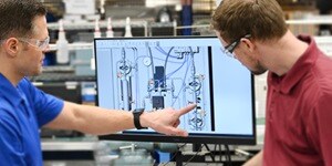 Two engineers reviewing fluid system design
