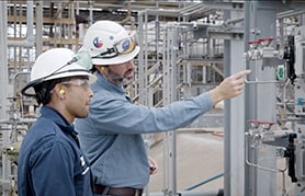 Field engineers inspecting an analytical instrumentation sampling system