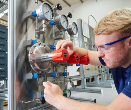 Technician installing a pressure regulator