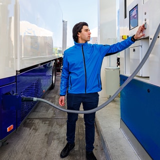 Man refueling a heavy-duty hydrogen fuel cell truck 