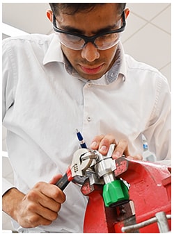 Engineer adjusting a pressure regulator