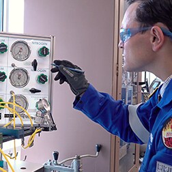 Swagelok field engineer inspects gas distribution panel in a lab