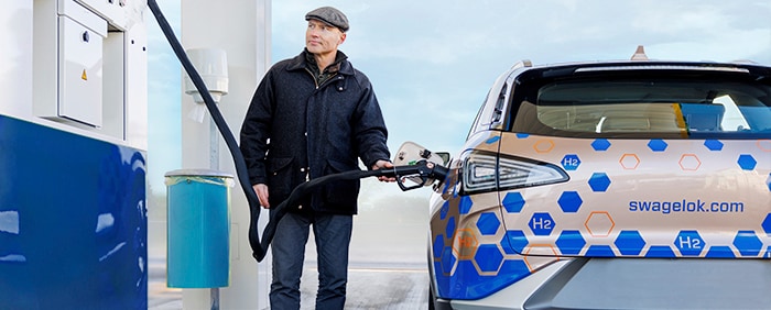 Man refueling a hydrogen vehicle