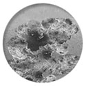 A close-up photograph of pitting corrosion affecting stainless steel
