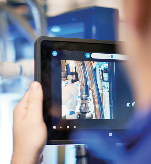 Swagelok Field Engineer analyzes fluid system using tablet computer