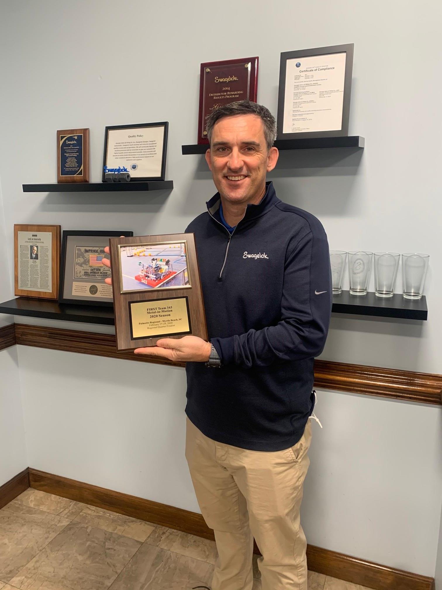 Dan holding Robotics Team Plaque