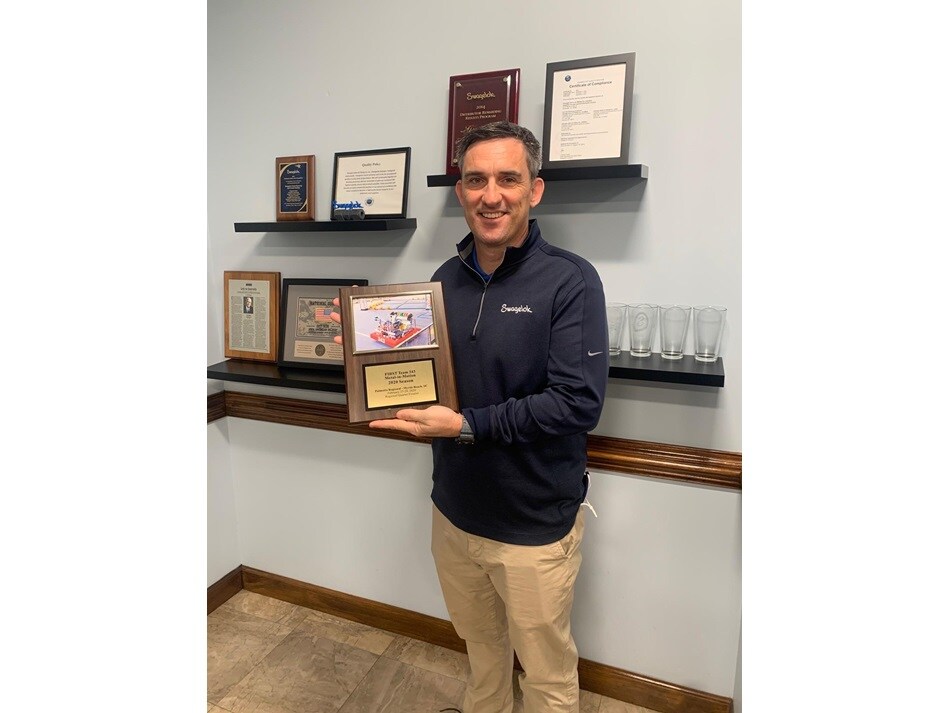 Dan holding Robotics Team Plaque