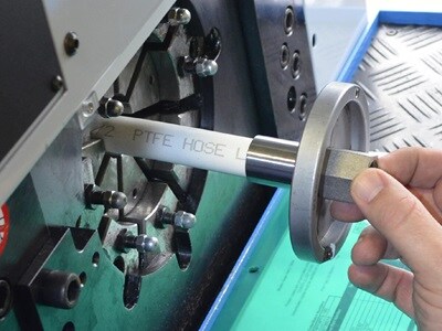 Swagelok technician assembling hoses with precision, ensuring secure and leak-free connections for fluid and gas transport in industrial systems.
