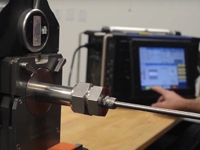 Swagelok technician performing orbital welding on piping components, providing high-quality welds for critical fluid systems in industrial settings.
