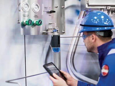 A Swagelok expert analyzing a sampling system setup, ensuring proper functionality and reliability in an industrial setting.