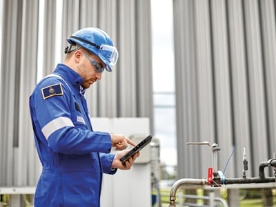 A Swagelok specialist conducting a steam system audit, inspecting piping and components for efficiency and safety improvements.