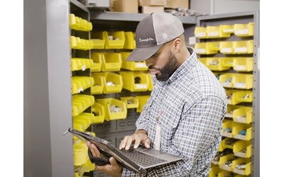 Swagelok professional managing vendor-managed inventory, organizing and tracking stock levels to ensure seamless fluid system operations.