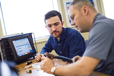Two men working with an orbital welder