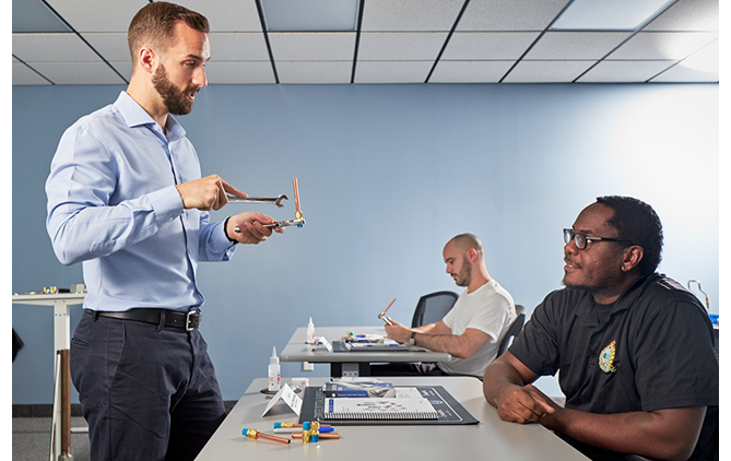 Two men at a hands on training at Swagelok