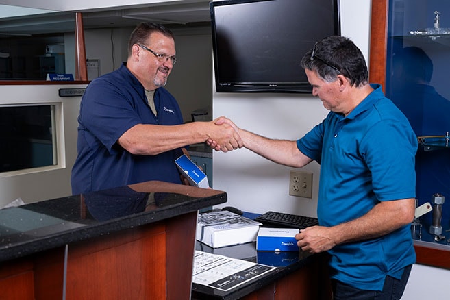 customer picking up order shaking hands