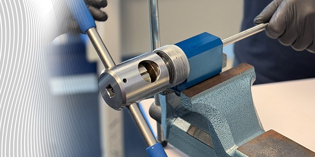 Medium‑ and high‑pressure cone and thread fitting assembled in a controlled bench setup.