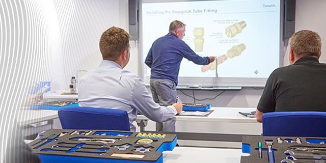 Technical classroom training focused on tube fitting installation with tools and components