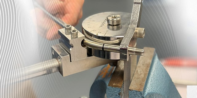 Stainless steel tubing formed and measured using precision tools during fluid system training.