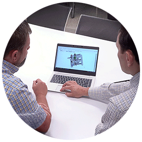 Men looking at a fluid system assembly rendering on a computer screen