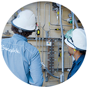 Swagelok field engineer assessing fluid system with customer