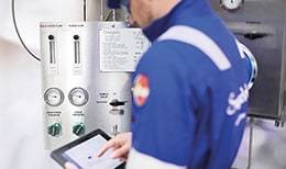 An engineer checks a closed loop sampling panel