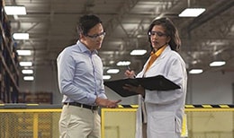 Workers discuss process measurement in a plant